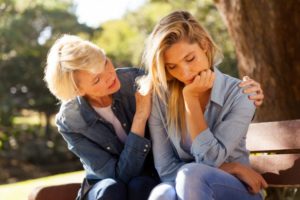A woman helping a grieving friend know you are now alone 