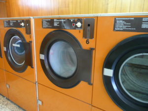 Three clothes dryers sitting side-by-side, the same kind used to dry bones in alkaline hydrolysis 