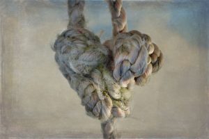 Rope tied into a heart shows pent up feelings about suicide