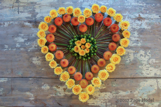 Handmade heart of yellow and orange flowers 