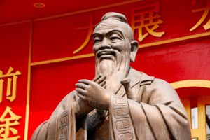 A statue of Confucius wearing a long robe
