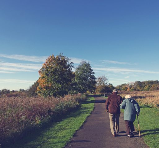 Elderly couple walking symbolizing aging.