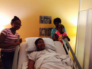 Woman in hospice with her daughters