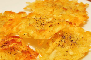 Hash browns sitting on a plate, which have been linked to fried potatoes and early death