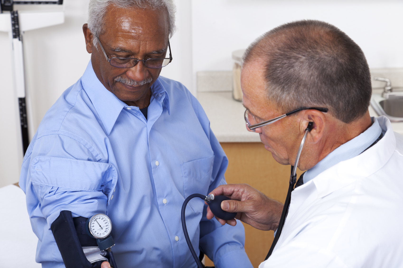 Overweight man getting blood pressure checked 