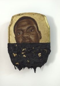Black man with tar on his face
