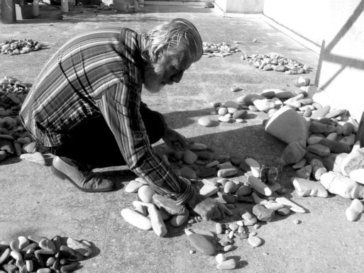 Nizar Ali Badr working with stones at his home in Syria