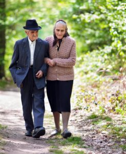 Senior man and woman walking together. Even couples can be victims of elder abuse.