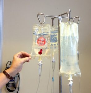 A person touches a chemotherapy bag, which is part of the treatment plan for patients to receive Keytruda
