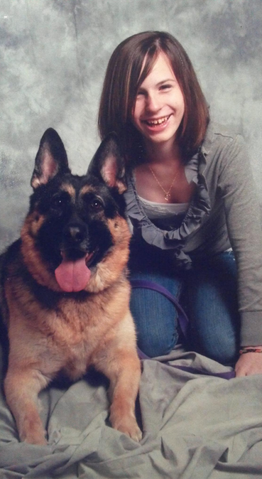A photo of Justina Pelletier, who was diagnosed with mitochondrial disease, and her dog, a German Shepherd