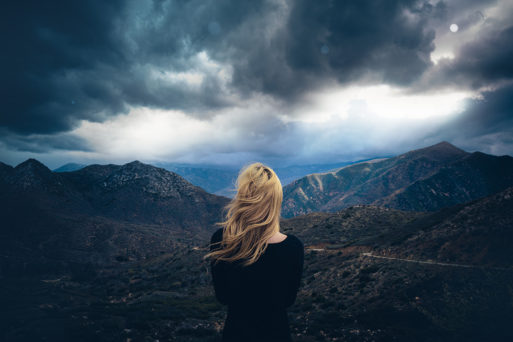 Woman looking out over a gathering storm
