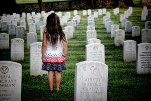A girl stands at her parent's grave, like the young girl in "I'm Here"