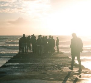 Group of people standing on a pier