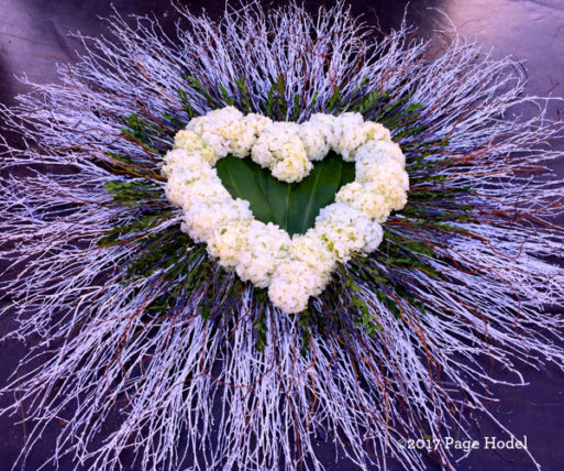 Purple dried flowers around a white handmade heart