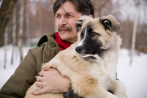 Man holding a dog symbolizing comfort