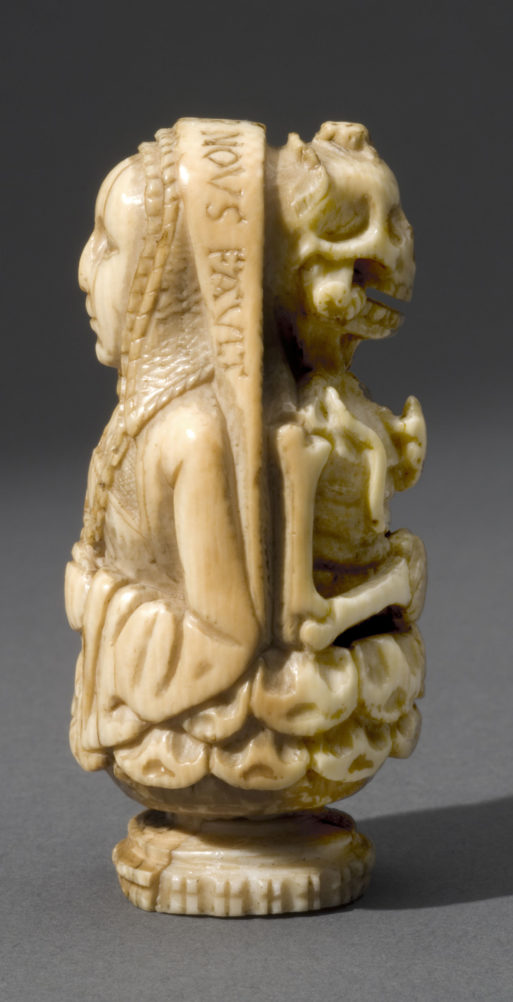 A prayer bead on exhibit in "The Ivory Mirror" shows a human on one side and a skeleton on the other
