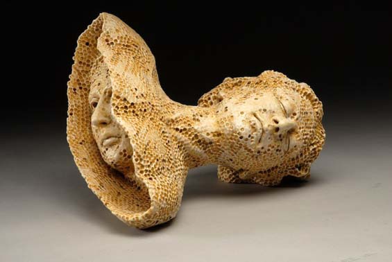 A sculpture about loss, featuring a woman's head and shoulders that is made out of ceramic honeycomb, with another woman's head emerging from the base of the woman's shoulders