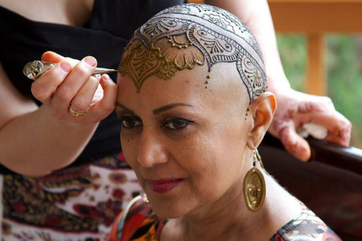 Woman with cancer getting a henna tattoo