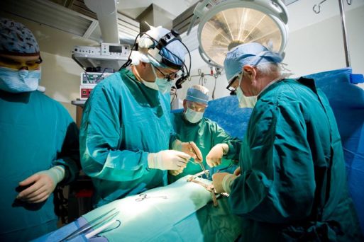 Surgeons performing heart surgery