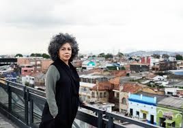 Doris Salcedo stands on a balcony in Colombia