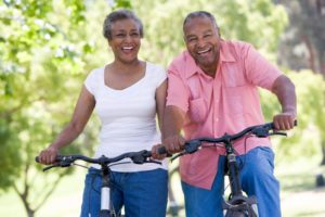 Elderly couple riding bicycles symbolizing exercise