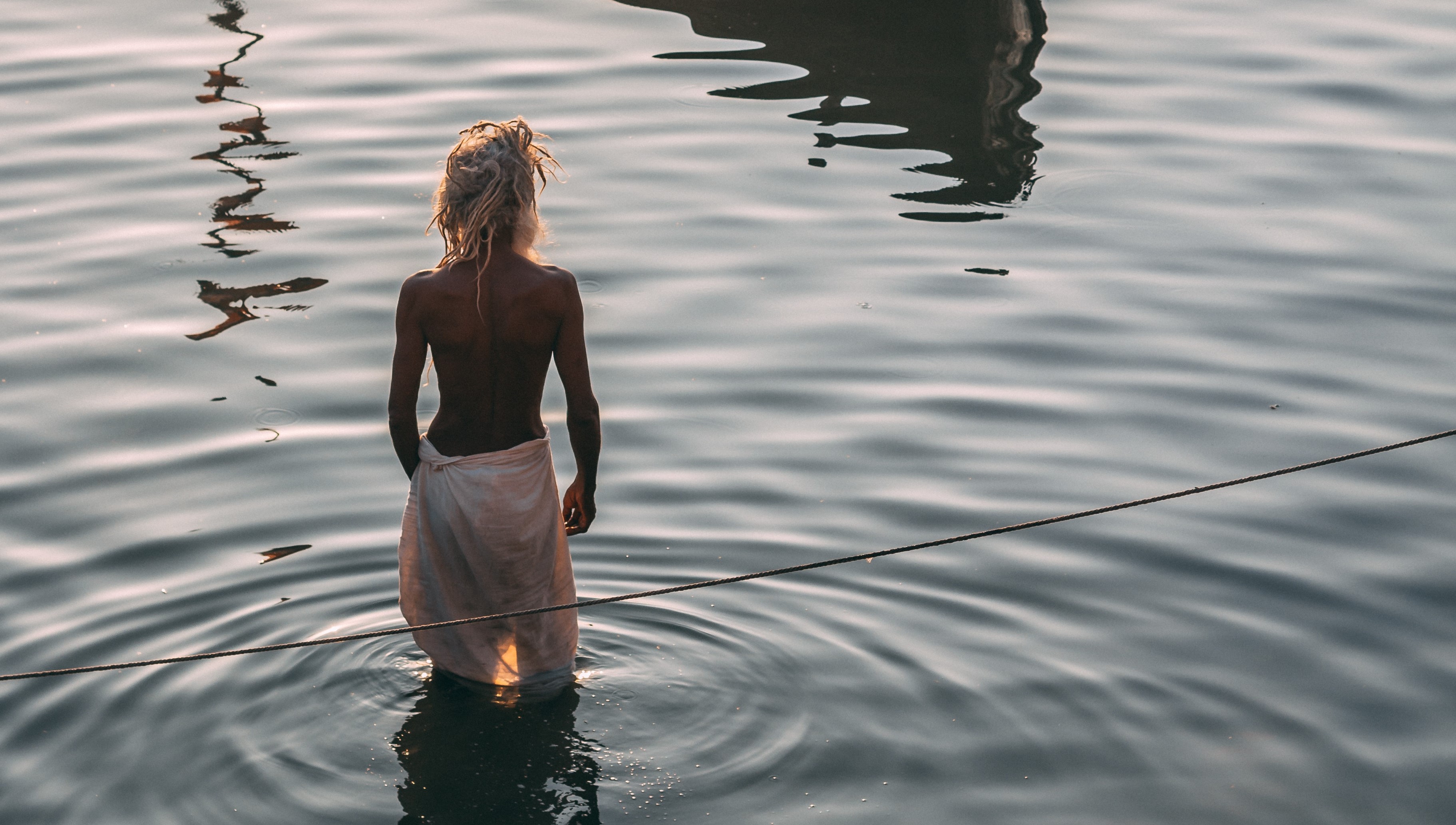 Indian Man in Ganges River near Burning Ghats