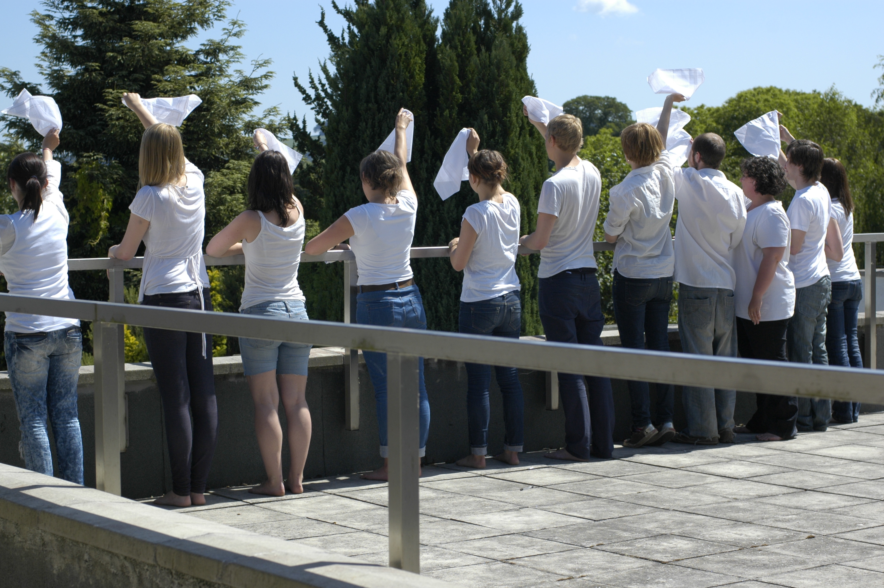 an image of people waving mourning handkerchiefs