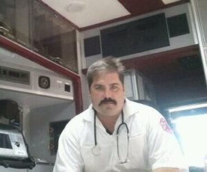 A photo of Dennis Kowalski sitting in an emergency vehicle. Dennis deals with emergency medical situations all the time