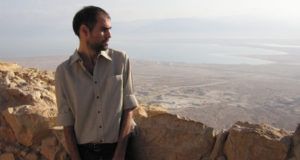 Ben Byer, director of "Indestructible," standing atop a rock fixture in Jerusalem