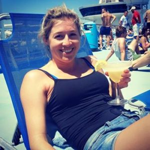 Photo of Holly Butcher drinking a cocktail sitting in a blue beach chair long before she wrote a "note before I die"