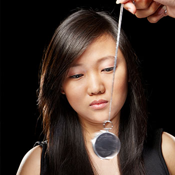 A woman works with a hypnotherapist