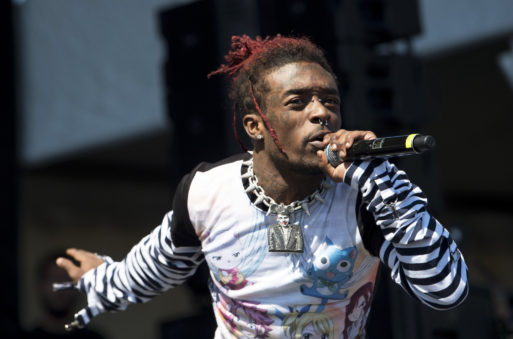 Lil Uzi Vert performing a song on stage symbolizing the rise of death as a topic in pop music