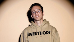 Portrait of rapper Logic wearing a sweater symbolizing the rise of deathly topics in pop music.