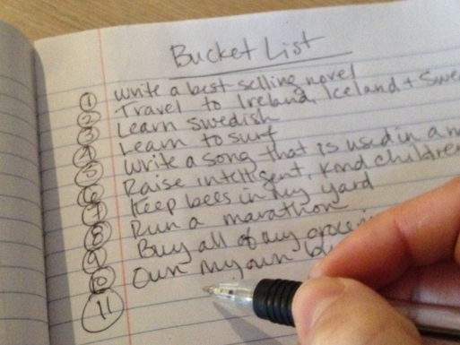 Photo of a hand writing a personalized bucket list
