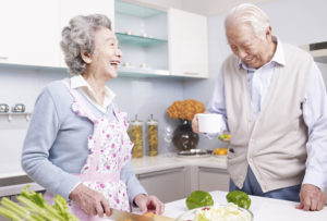 Elderly couple smiling in kitchen