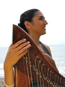 Portia Diwa who plays healing harp music for patients and families
