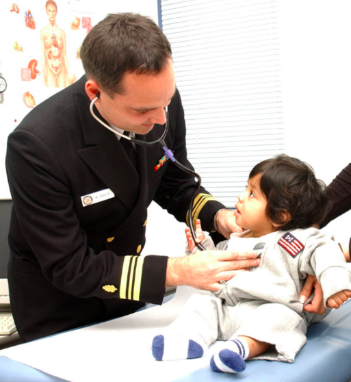 Military male nurse tends child, showing males nurses fill many roles