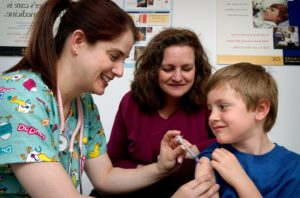 Nurse giving an injection shows healthcare jobs growth