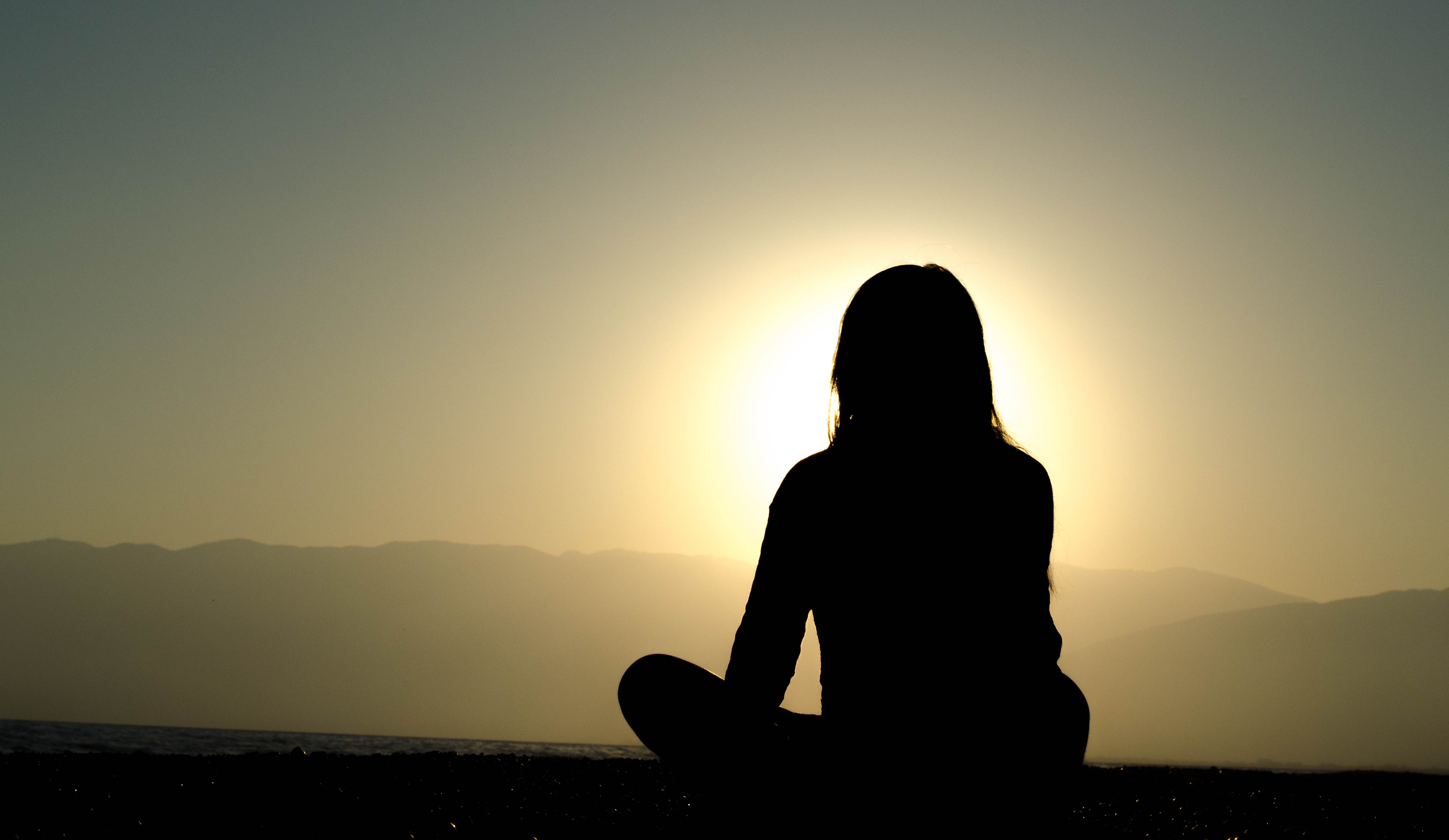 An image of a silhouette of someone engaging in yoga for grief