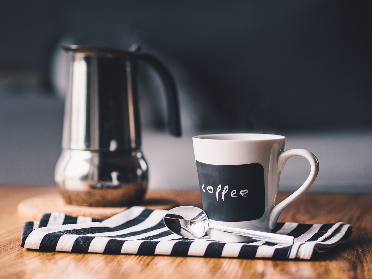Cup of coffee and brewing device resting on kitchen counter seems appropriate for Death Cafes
