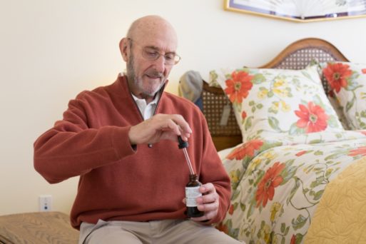 Image of a senior citizen using a medical cannabis tincture