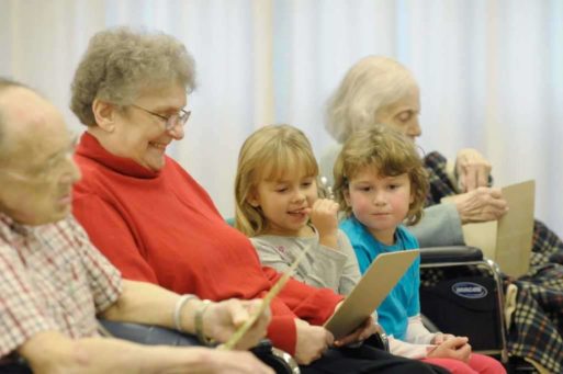 Seniors and children interacting display intergenerational communication