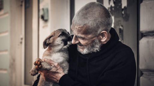 Image of an elderly man and dog as he considers pet hospice
