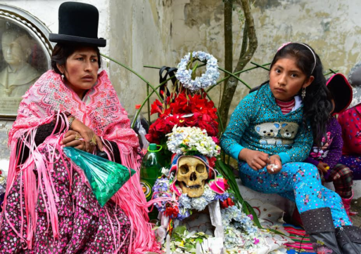 Armayan woman and child sitting next to a ñatita skull