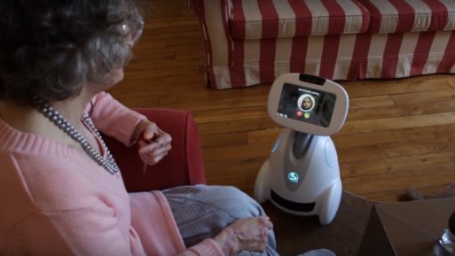 image of woman using Buddy, the caregiving robot