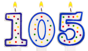 Blue and white numerical birthday candles forming the number 105, a symbol of longevity
