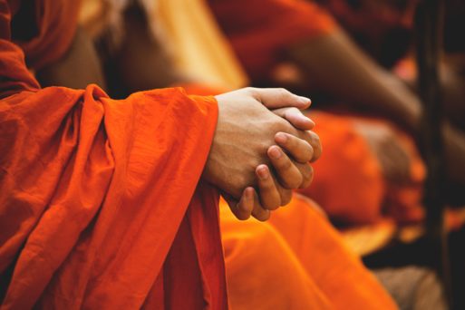An image of monk's hands as they prepare for their graceful exits