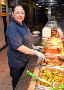Service workers like this woman at a lunch line may encounter overdoses at work