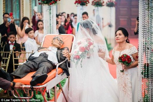 Photo of a terminally ill father accompanying his daughter down her wedding aisle while laying in a stretcher.