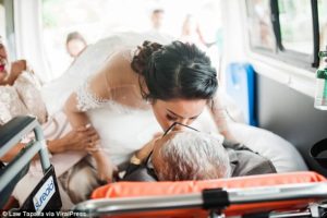 Photo of Charlotte Villarin kissing her terminally ill father Pedro in the back of an ambulance